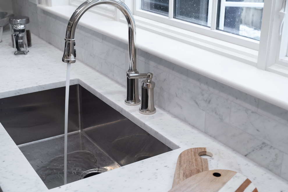 Inspiration for a huge timeless l-shaped dark wood floor and brown floor eat-in kitchen remodel in Boston with an undermount sink, beaded inset cabinets, white cabinets, marble countertops, gray backsplash, marble backsplash, stainless steel appliances, an island and white countertops
