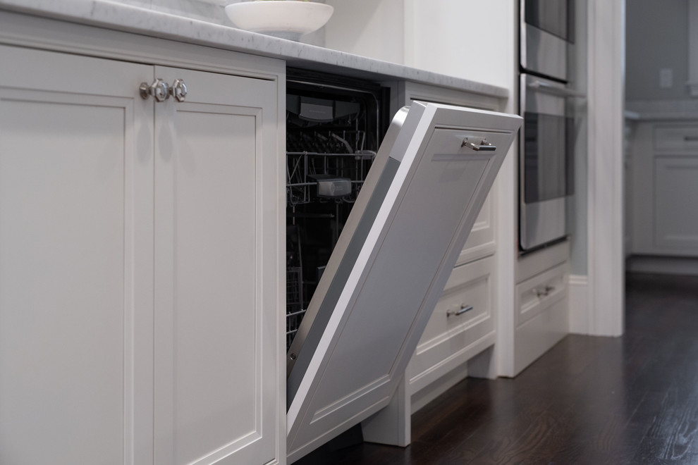 Inspiration for a huge timeless l-shaped dark wood floor and brown floor eat-in kitchen remodel in Boston with an undermount sink, beaded inset cabinets, white cabinets, marble countertops, gray backsplash, marble backsplash, stainless steel appliances, an island and white countertops
