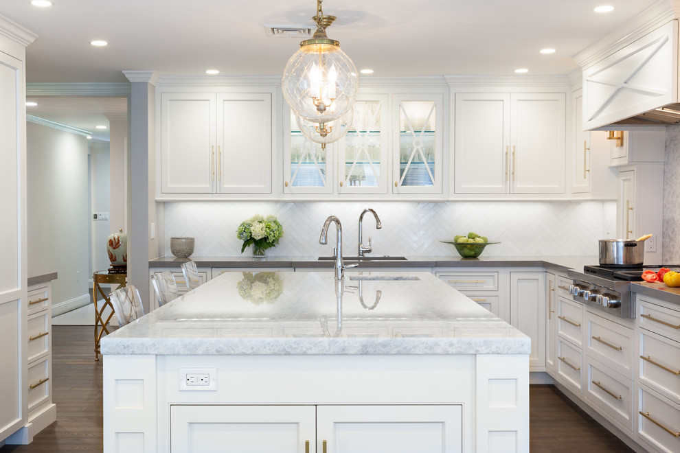 Inspiration for a modern eat-in kitchen remodel in Boston with beaded inset cabinets, white cabinets, quartz countertops, gray backsplash, stone slab backsplash, stainless steel appliances and an island