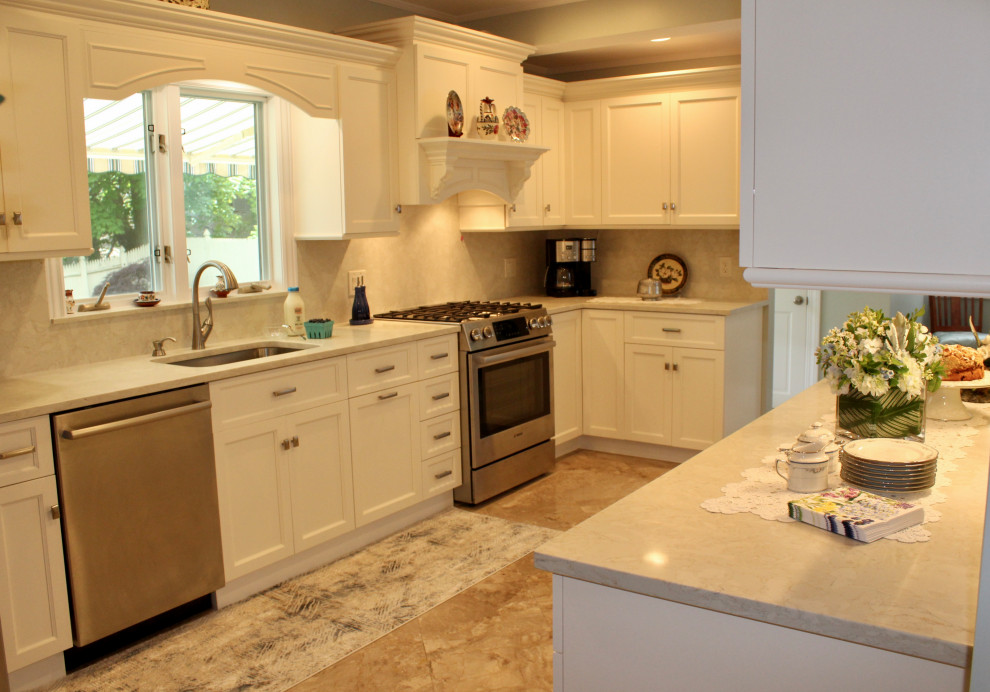 Example of a mid-sized classic l-shaped marble floor and beige floor eat-in kitchen design in Boston with an undermount sink, recessed-panel cabinets, white cabinets, quartz countertops, beige backsplash, quartz backsplash, stainless steel appliances, no island and beige countertops