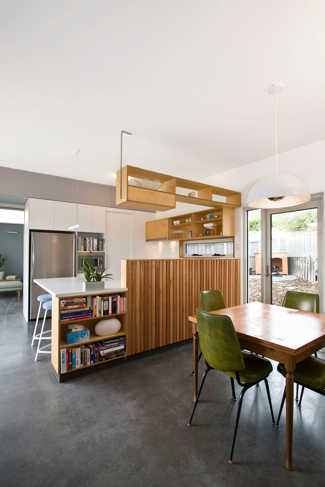 Example of a mid-sized trendy u-shaped open concept kitchen design in Hobart with a double-bowl sink, open cabinets, light wood cabinets, solid surface countertops, white backsplash, ceramic backsplash, stainless steel appliances and no island