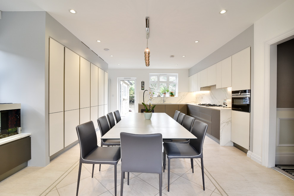 This is an example of a contemporary u-shaped kitchen/diner in London with a submerged sink, flat-panel cabinets, white cabinets, white splashback, black appliances, no island, beige floors and white worktops.
