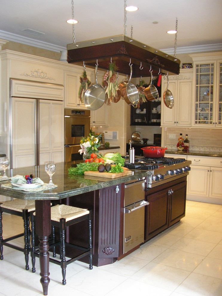 This is an example of a traditional kitchen in San Diego with raised-panel cabinets, white cabinets, white splashback and integrated appliances.