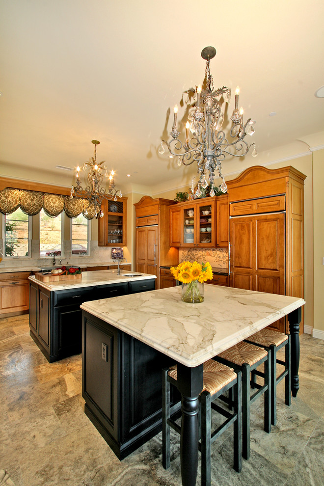 Elegant kitchen photo in San Diego with marble countertops and two islands