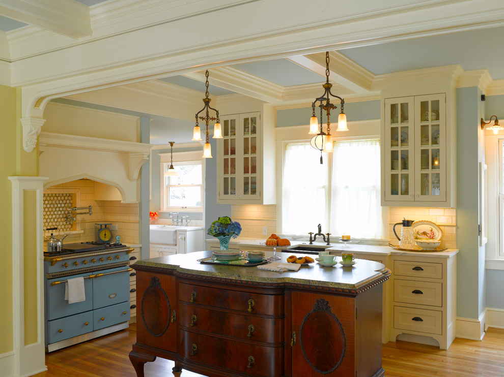 Large french country medium tone wood floor eat-in kitchen photo in Seattle with subway tile backsplash, a single-bowl sink, white cabinets, granite countertops, white backsplash, an island and glass-front cabinets