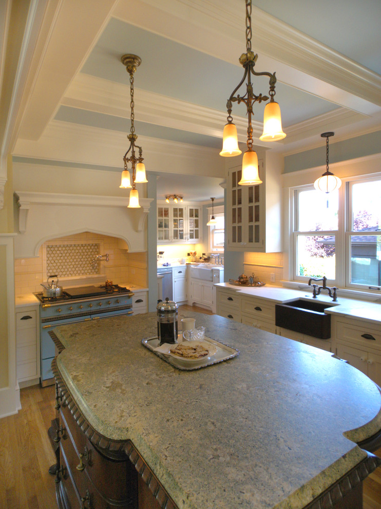 This is an example of a large victorian l-shaped kitchen/diner in Seattle with a single-bowl sink, recessed-panel cabinets, white cabinets, granite worktops, white splashback, metro tiled splashback, light hardwood flooring and an island.