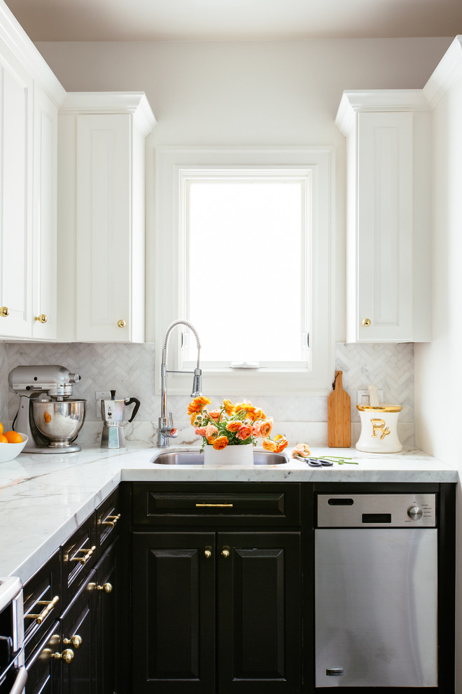 Inspiration for a small transitional l-shaped dark wood floor eat-in kitchen remodel in San Francisco with an undermount sink, raised-panel cabinets, white cabinets, marble countertops, white backsplash, stone tile backsplash, stainless steel appliances and no island