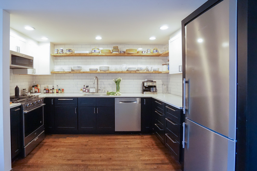 Small transitional u-shaped medium tone wood floor and brown floor enclosed kitchen photo in San Francisco with a single-bowl sink, shaker cabinets, white cabinets, quartzite countertops, white backsplash, ceramic backsplash, stainless steel appliances, no island and white countertops