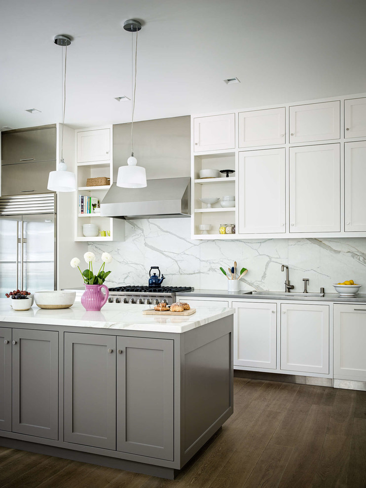 Traditional grey and white kitchen in San Francisco with a submerged sink, shaker cabinets, white cabinets, white splashback, stainless steel appliances, medium hardwood flooring, an island and marble splashback.