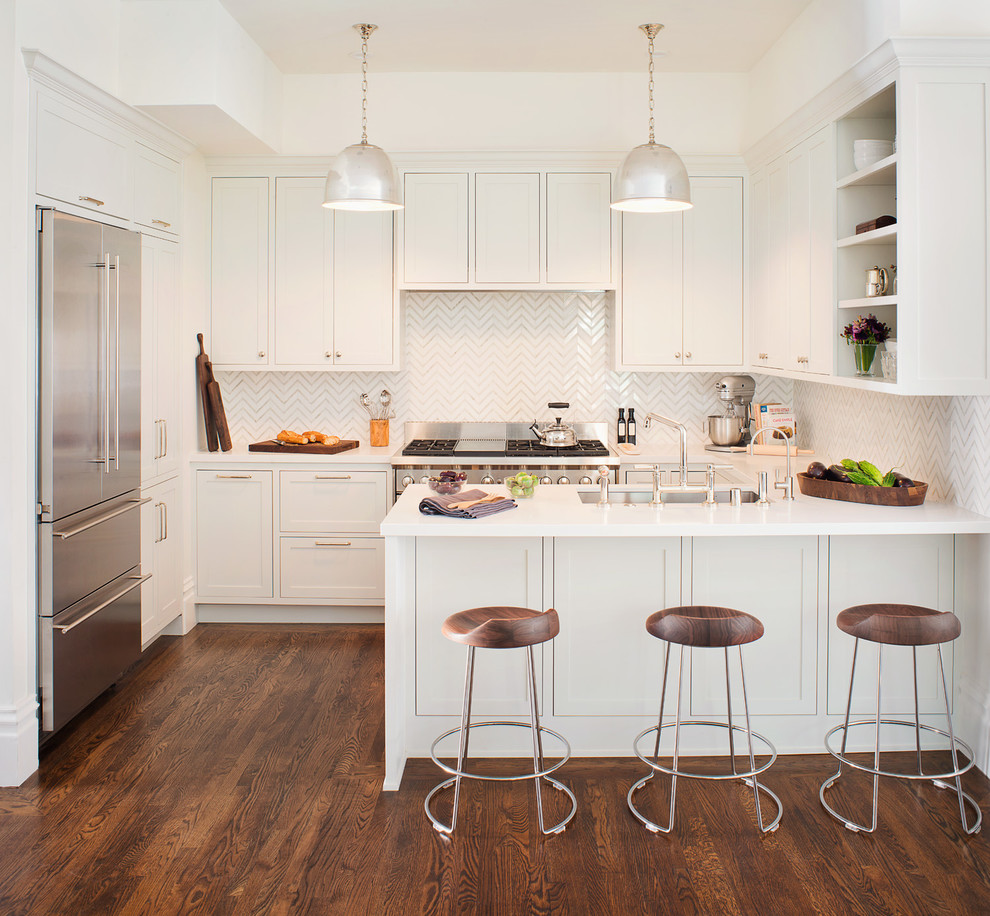 Example of a transitional u-shaped dark wood floor kitchen design in San Francisco with flat-panel cabinets, white cabinets, white backsplash and a peninsula