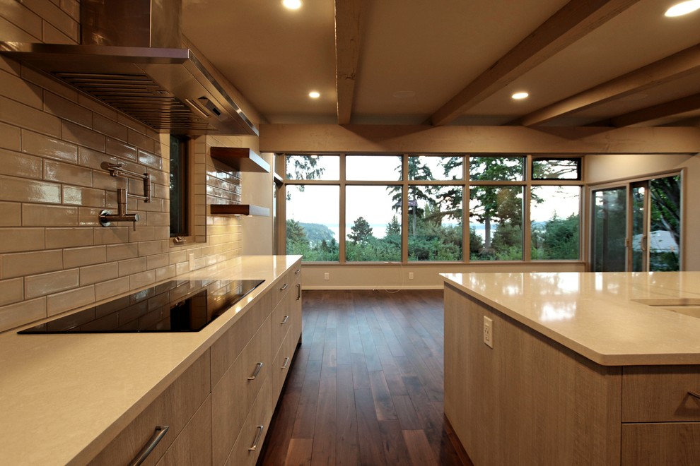 This is an example of a large retro l-shaped open plan kitchen in Seattle with a submerged sink, flat-panel cabinets, grey cabinets, engineered stone countertops, white splashback, ceramic splashback, stainless steel appliances, dark hardwood flooring, an island, brown floors and white worktops.