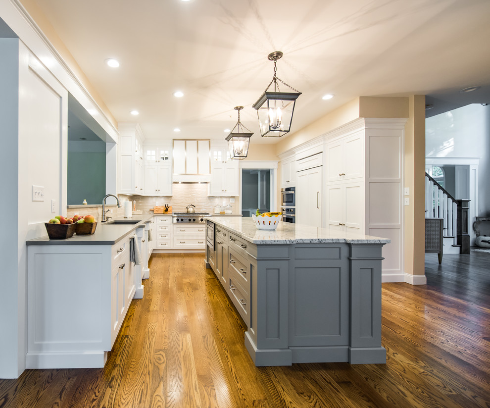 Mid-sized elegant dark wood floor enclosed kitchen photo in Boston with an undermount sink, shaker cabinets, stainless steel appliances, an island, white cabinets, granite countertops, beige backsplash and porcelain backsplash