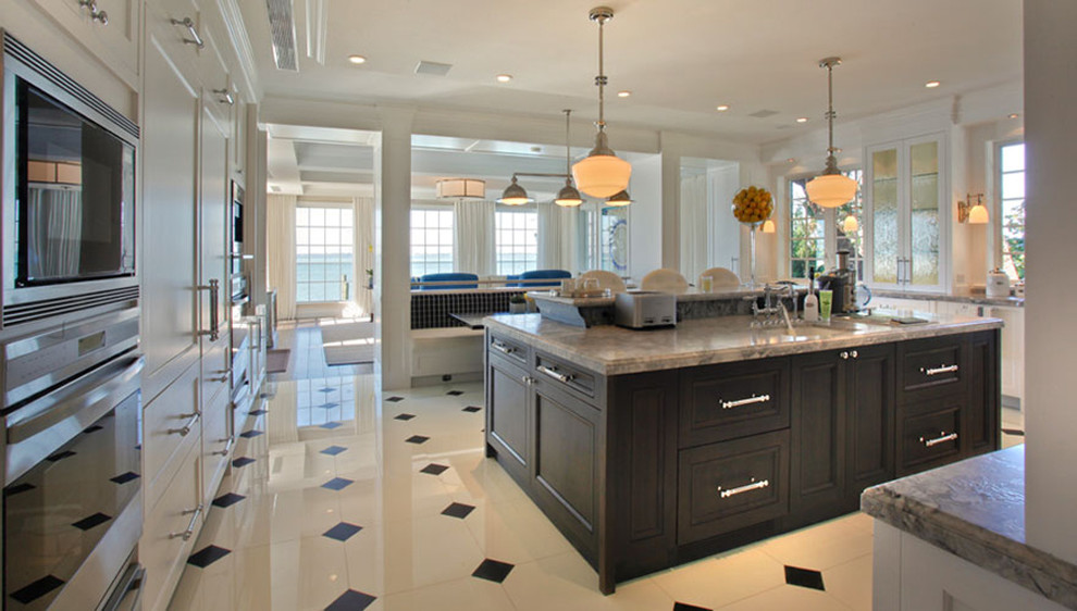 Example of a huge classic u-shaped eat-in kitchen design in Miami with a farmhouse sink, raised-panel cabinets, dark wood cabinets, marble countertops, white backsplash, stone slab backsplash, paneled appliances and an island