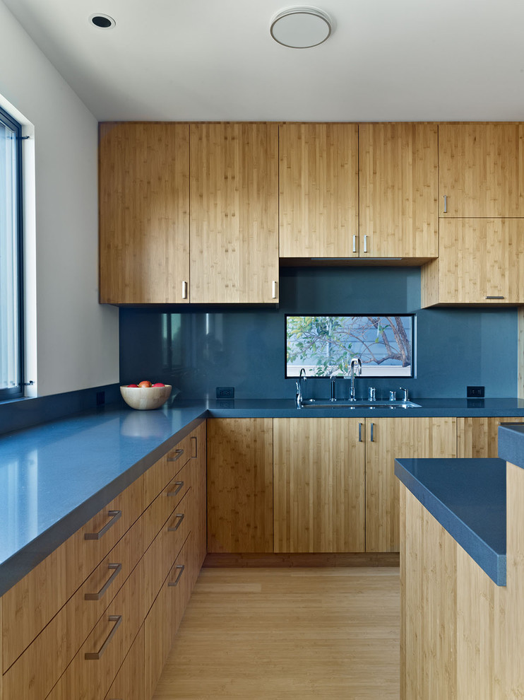 Minimalist kitchen photo in San Francisco with flat-panel cabinets, medium tone wood cabinets, blue backsplash and blue countertops
