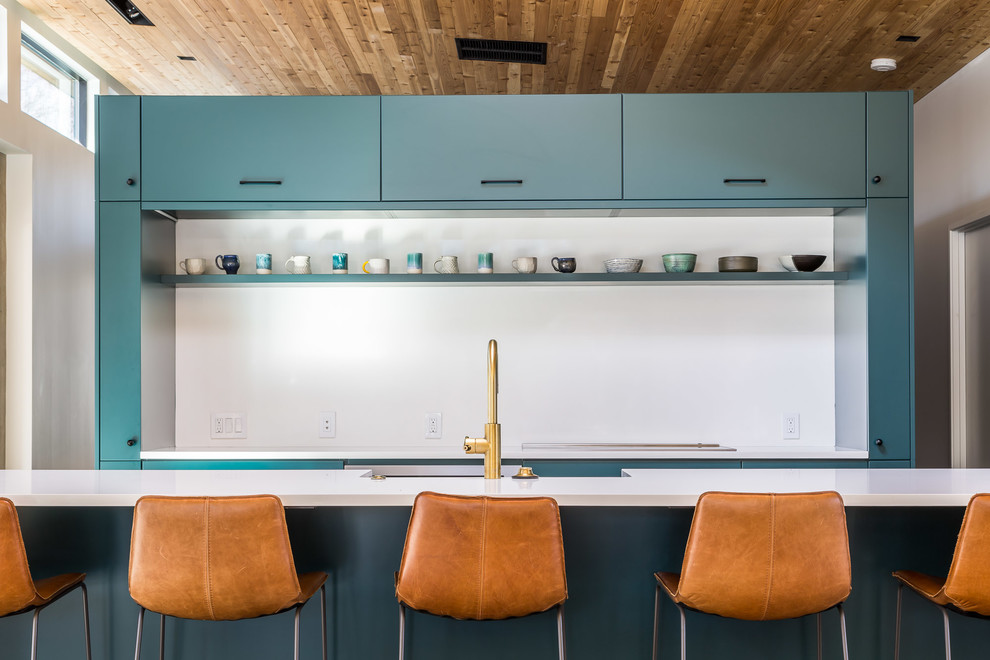 Inspiration for a modern eat-in kitchen remodel in Denver with a farmhouse sink, flat-panel cabinets, green cabinets, quartz countertops, white backsplash, paneled appliances, an island and white countertops