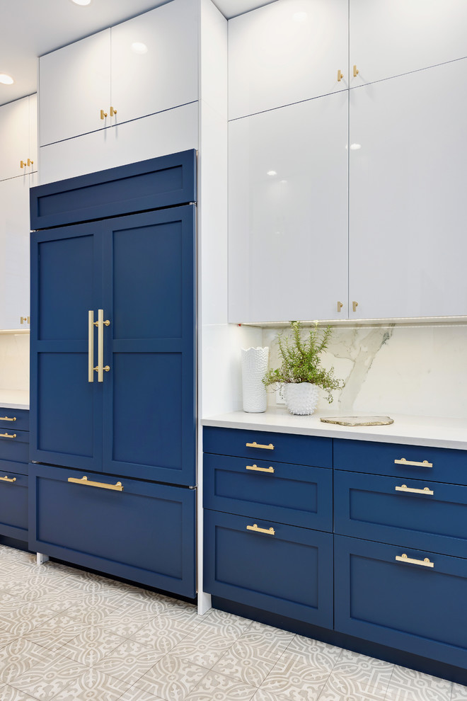 Inspiration for a large traditional l-shaped enclosed kitchen in Chicago with a belfast sink, shaker cabinets, blue cabinets, quartz worktops, white splashback, marble splashback, integrated appliances, porcelain flooring, an island and white floors.
