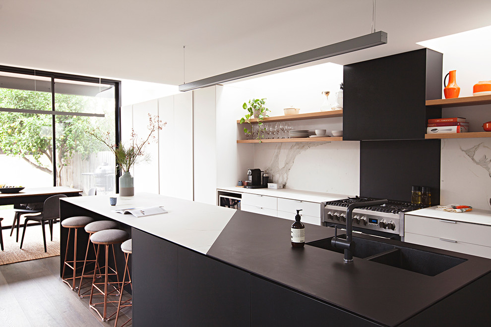Photo of a small contemporary open plan kitchen in Melbourne with marble worktops, dark hardwood flooring and an island.