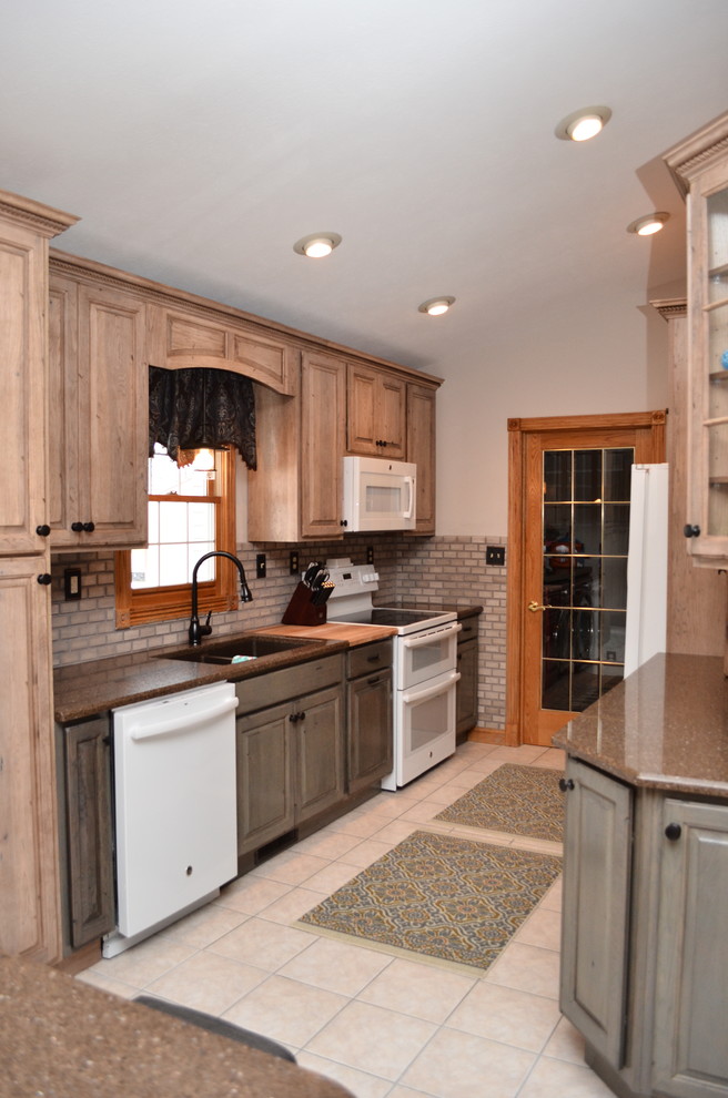 Mid-sized transitional galley ceramic tile and beige floor eat-in kitchen photo in Chicago with an island, an undermount sink, raised-panel cabinets, beige cabinets, quartzite countertops, brown backsplash, brick backsplash, white appliances and brown countertops