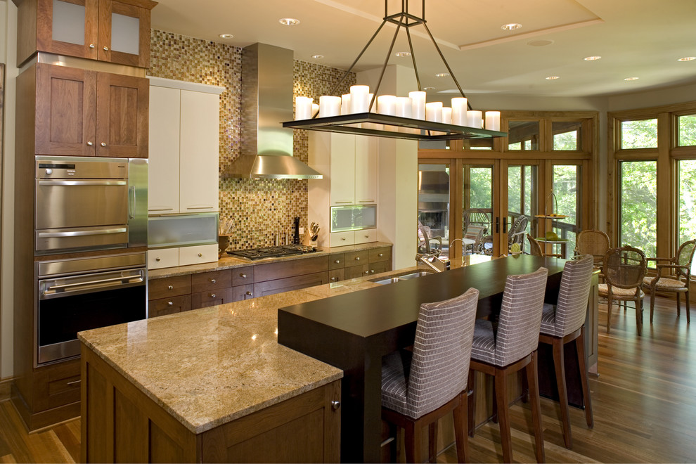 Large traditional galley kitchen/diner in Minneapolis with a submerged sink, flat-panel cabinets, dark wood cabinets, multi-coloured splashback, stainless steel appliances, medium hardwood flooring, an island, granite worktops and ceramic splashback.