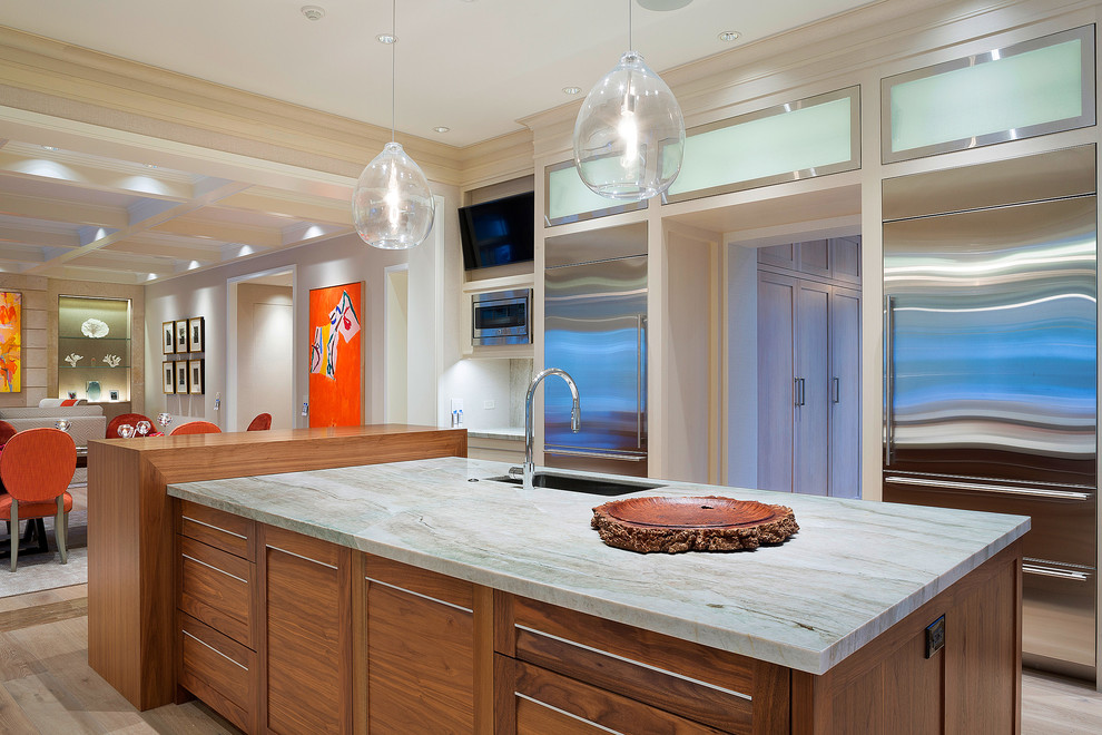 Eat-in kitchen - tropical eat-in kitchen idea in Other with an undermount sink, stainless steel appliances and an island