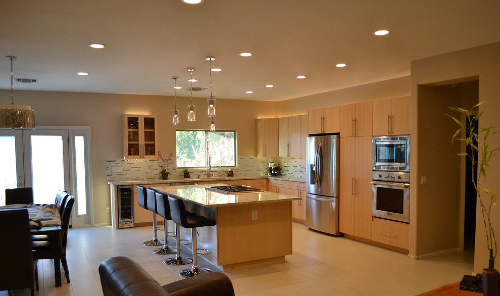 Eat-in kitchen - large contemporary l-shaped porcelain tile and beige floor eat-in kitchen idea in Phoenix with an undermount sink, flat-panel cabinets, light wood cabinets, granite countertops, multicolored backsplash, matchstick tile backsplash, stainless steel appliances and an island