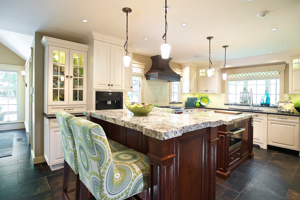 Eat-in kitchen - large traditional u-shaped slate floor and brown floor eat-in kitchen idea in Las Vegas with white cabinets, two islands, an undermount sink, beaded inset cabinets, quartzite countertops, white backsplash, glass tile backsplash and stainless steel appliances