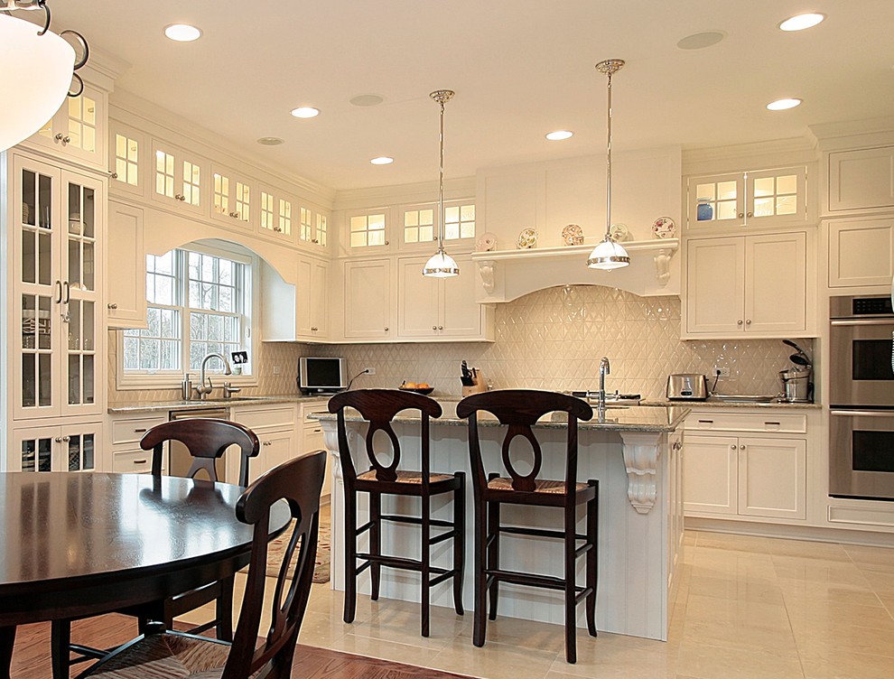 Inspiration for a traditional kitchen in Chicago with white cabinets and white splashback.