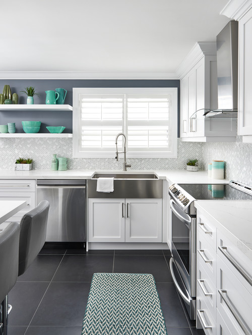 Stainless Steel Elegance: Farmhouse Sink and Glass Herringbone Tile Backsplash Concepts