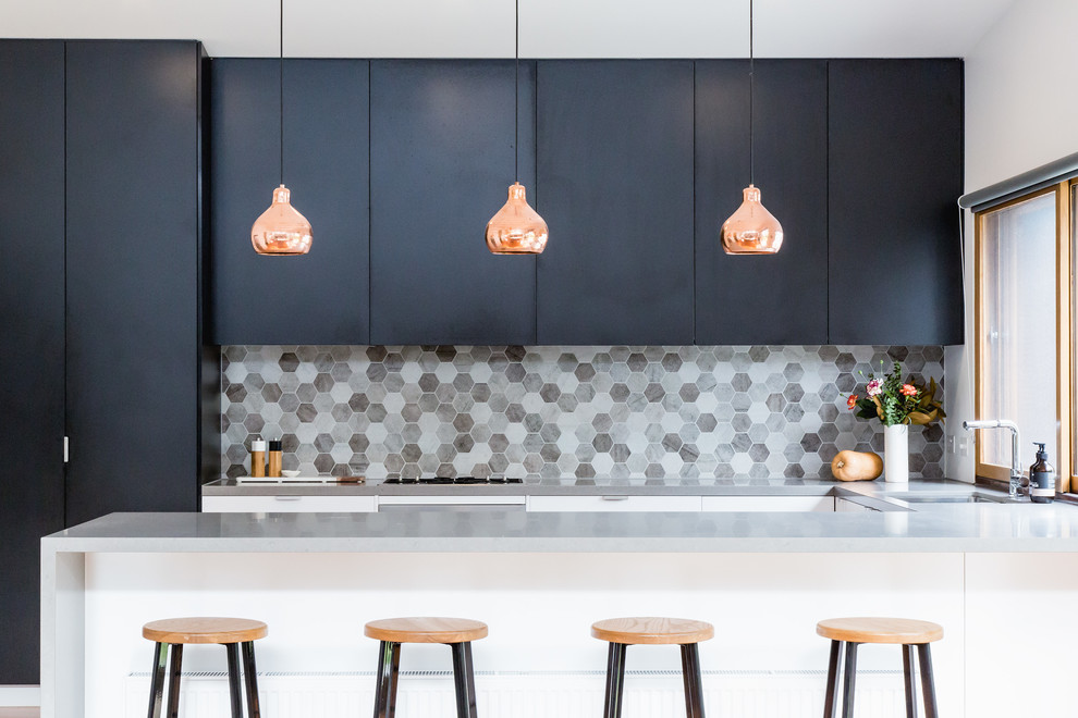 Inspiration for a contemporary u-shaped kitchen remodel in Melbourne with an undermount sink, flat-panel cabinets, black cabinets, gray backsplash, mosaic tile backsplash and a peninsula