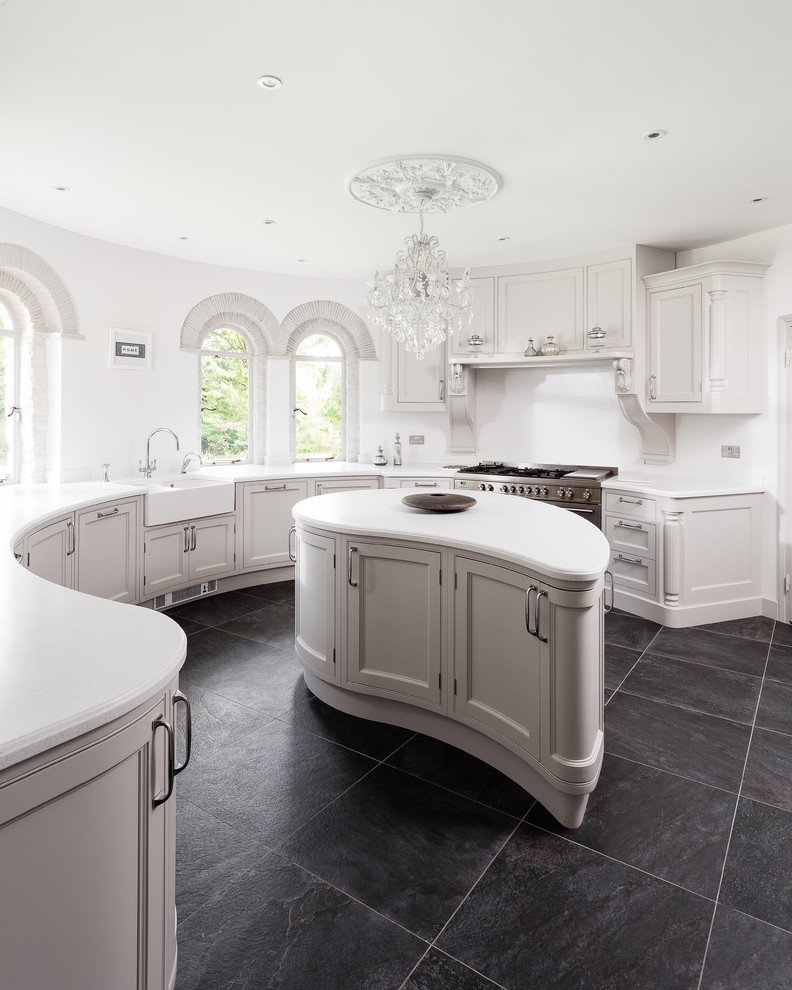 This is an example of an expansive classic kitchen/diner in Other with a double-bowl sink, recessed-panel cabinets, grey cabinets, composite countertops, white splashback, stainless steel appliances, porcelain flooring and an island.