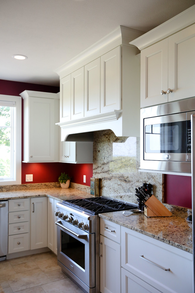 Example of a large arts and crafts u-shaped ceramic tile eat-in kitchen design in Other with an undermount sink, recessed-panel cabinets, white cabinets, granite countertops, red backsplash, wood backsplash, stainless steel appliances and an island