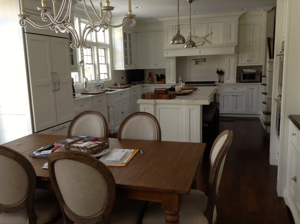 Inspiration for a classic kitchen in New York with recessed-panel cabinets, dark hardwood flooring and an island.