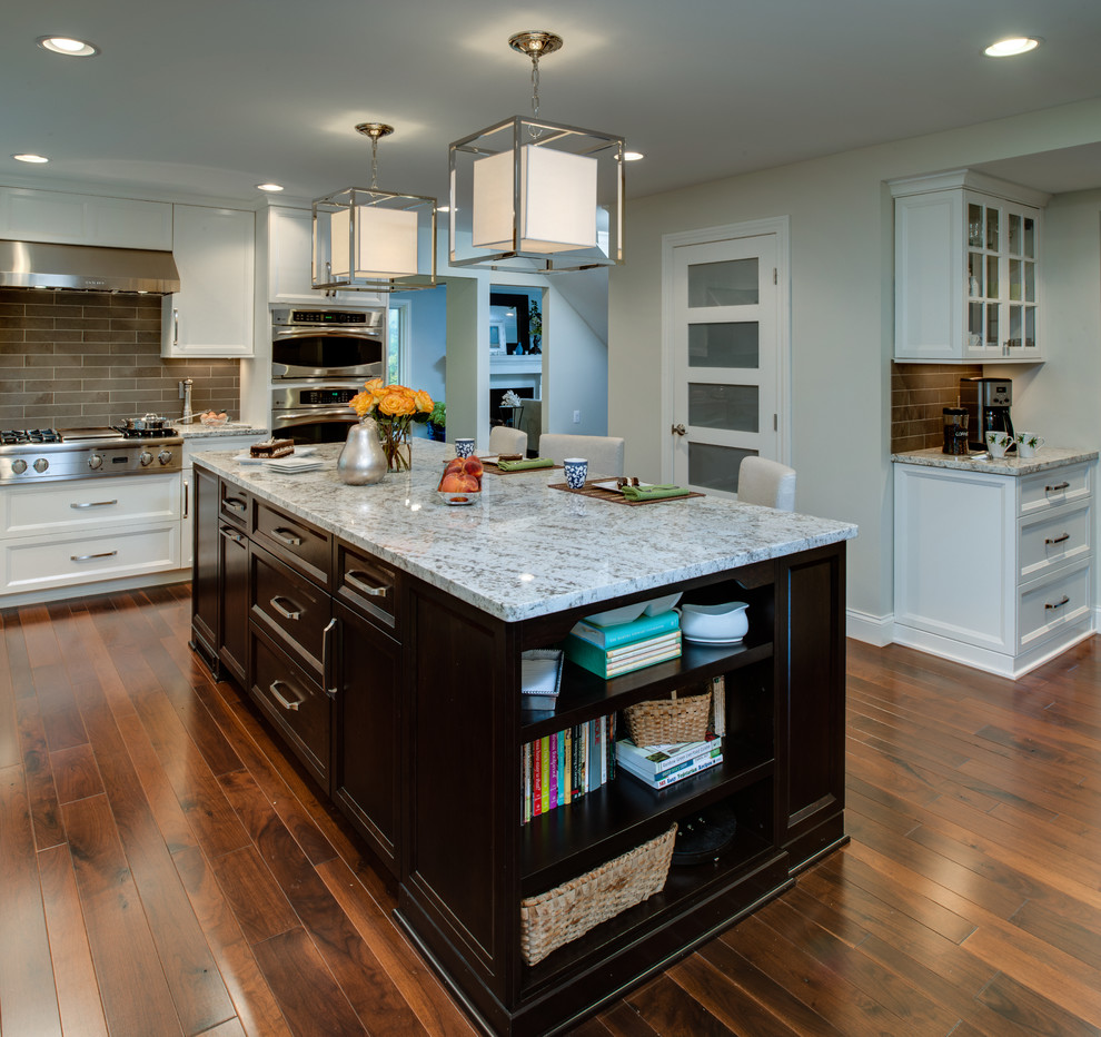 Eat-in kitchen - mid-sized transitional l-shaped dark wood floor eat-in kitchen idea in Detroit with an undermount sink, recessed-panel cabinets, white cabinets, granite countertops, gray backsplash, stone tile backsplash, stainless steel appliances and an island