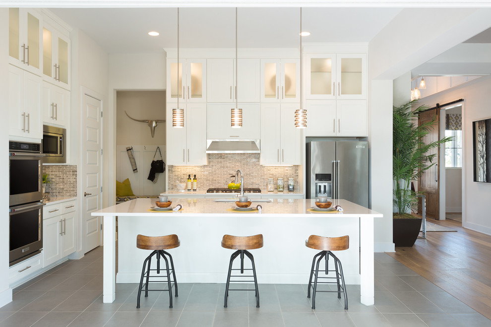 Inspiration for a classic kitchen in Austin with a submerged sink, shaker cabinets, white cabinets, multi-coloured splashback, mosaic tiled splashback, stainless steel appliances and an island.