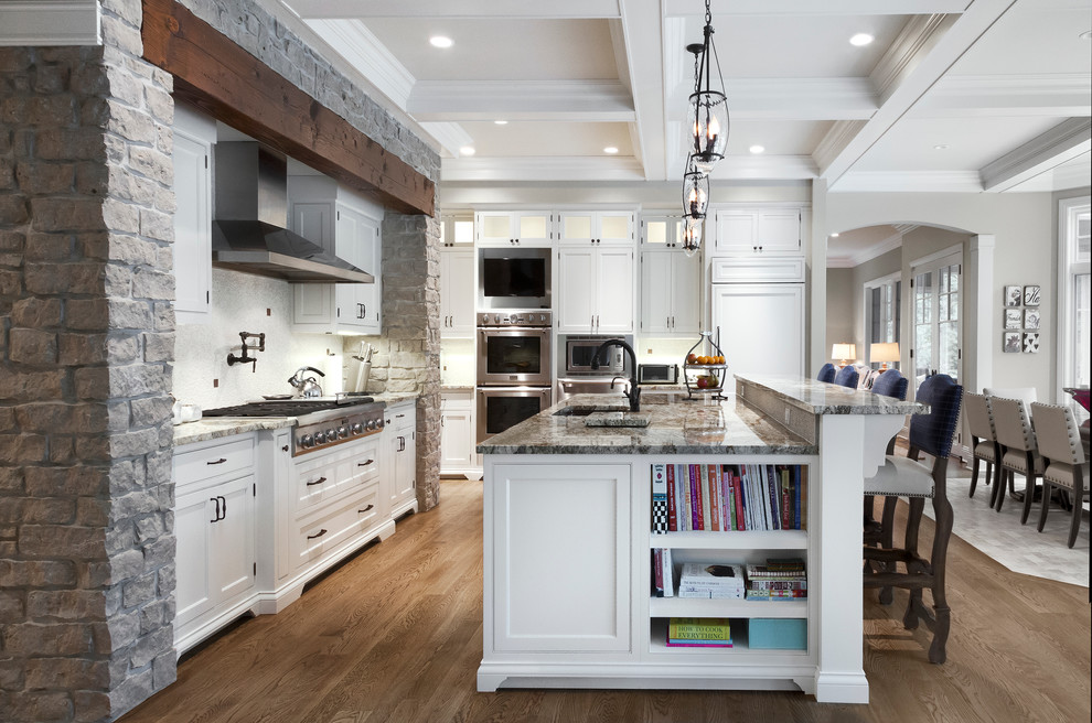 Example of a classic eat-in kitchen design in Chicago with an undermount sink, beaded inset cabinets, white cabinets, granite countertops, white backsplash and stainless steel appliances