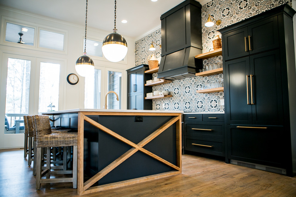 Inspiration for a mid-sized transitional single-wall dark wood floor and brown floor enclosed kitchen remodel in Atlanta with an undermount sink, shaker cabinets, black cabinets, quartz countertops, multicolored backsplash, ceramic backsplash, stainless steel appliances and an island