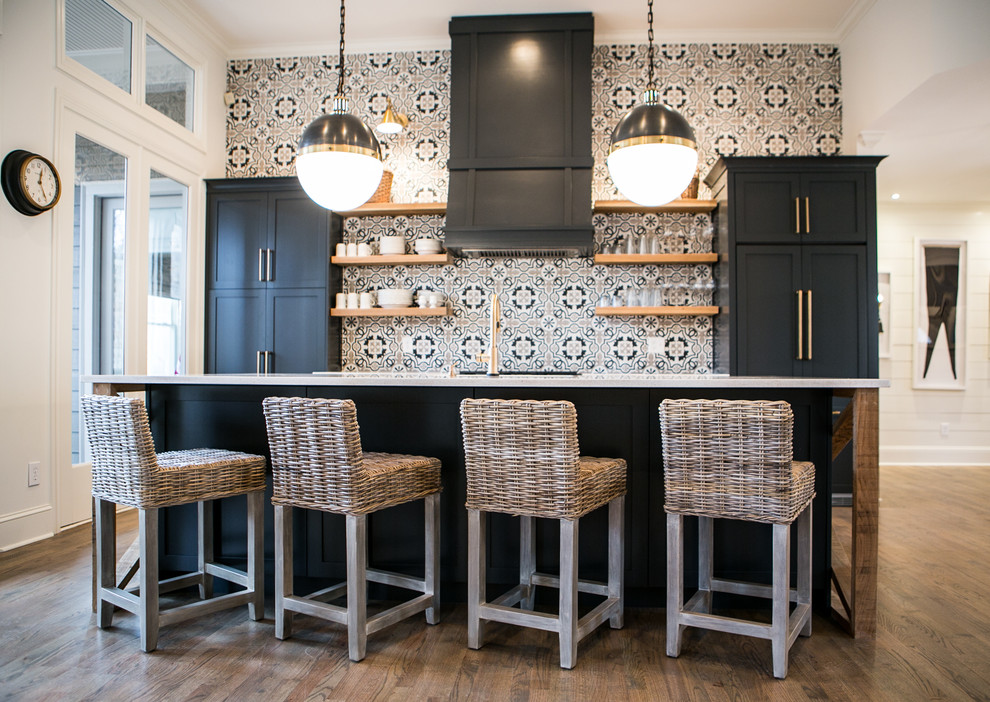 Inspiration for a mid-sized transitional single-wall dark wood floor and brown floor enclosed kitchen remodel in Atlanta with an undermount sink, shaker cabinets, black cabinets, quartz countertops, multicolored backsplash, ceramic backsplash, stainless steel appliances and an island