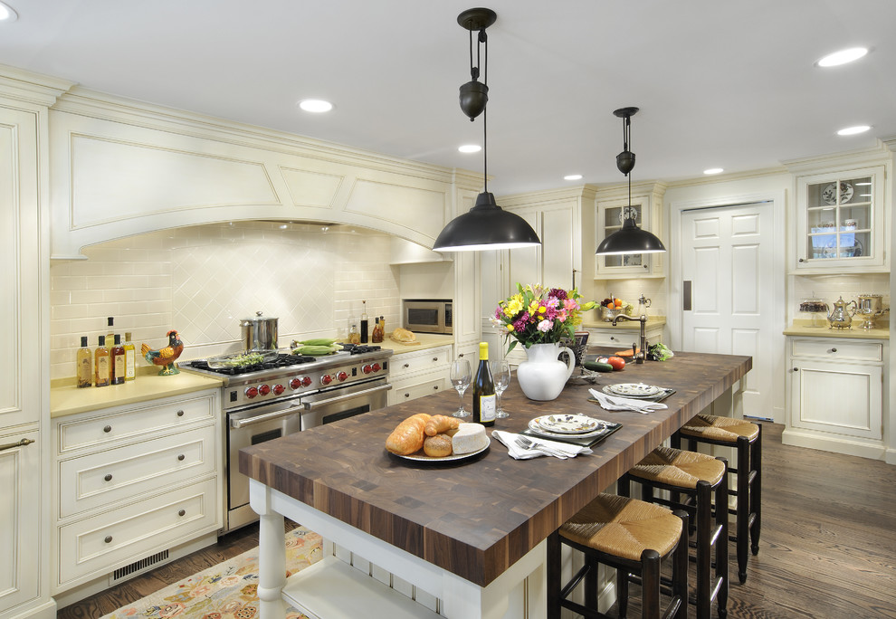 Inspiration for a victorian kitchen remodel in Chicago with stainless steel appliances and wood countertops