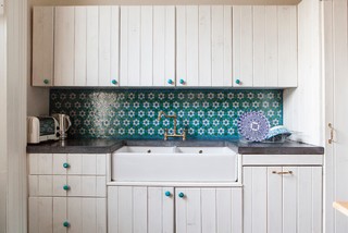 white kitchen with blue painted wood knobs