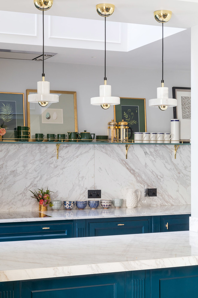 Small traditional u-shaped kitchen/diner in London with a submerged sink, shaker cabinets, blue cabinets, marble worktops, grey splashback, window splashback, stainless steel appliances, light hardwood flooring, an island, beige floors and grey worktops.