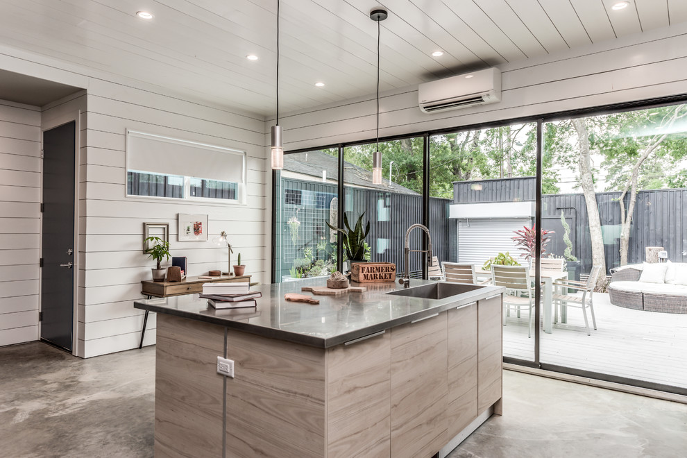 Design ideas for a small modern galley kitchen/diner in Houston with an integrated sink, flat-panel cabinets, dark wood cabinets, stainless steel worktops, white splashback, stone slab splashback, stainless steel appliances, concrete flooring, an island, grey floors and grey worktops.