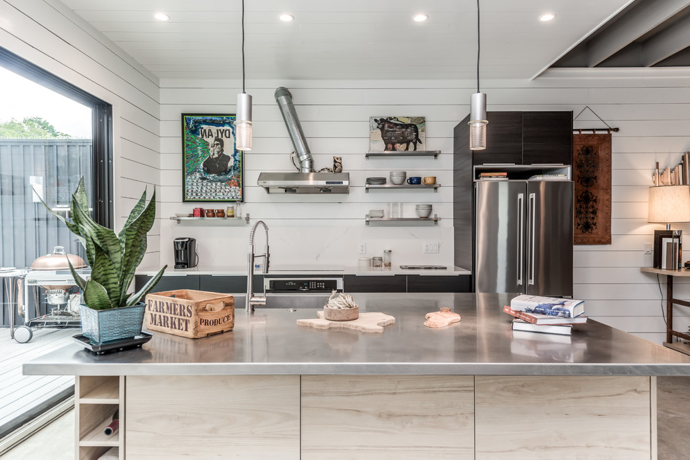Design ideas for a small modern galley kitchen/diner in Houston with an integrated sink, flat-panel cabinets, dark wood cabinets, stainless steel worktops, white splashback, stone slab splashback, stainless steel appliances, concrete flooring, an island, grey floors and grey worktops.