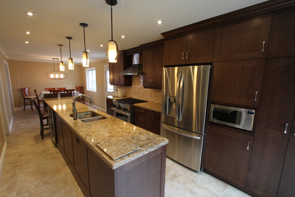 Large trendy single-wall porcelain tile eat-in kitchen photo in Toronto with an undermount sink, shaker cabinets, medium tone wood cabinets, quartz countertops, beige backsplash, mosaic tile backsplash, stainless steel appliances and an island