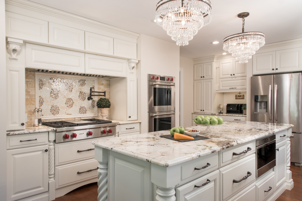 Mid-sized elegant medium tone wood floor eat-in kitchen photo in St Louis with a farmhouse sink, raised-panel cabinets, yellow cabinets, granite countertops, beige backsplash, stone tile backsplash, white appliances and an island