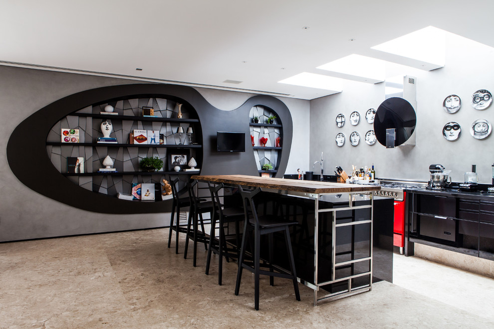 Inspiration for a contemporary galley kitchen remodel with flat-panel cabinets, black cabinets, wood countertops and colored appliances