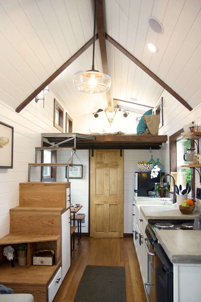 Open concept kitchen - small farmhouse single-wall open concept kitchen idea in Portland with white cabinets and no island