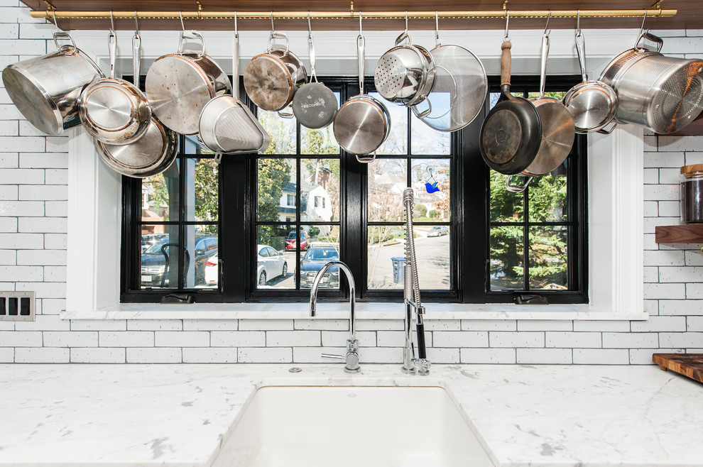 Inspiration for a mid-sized shabby-chic style u-shaped dark wood floor open concept kitchen remodel in DC Metro with a farmhouse sink, recessed-panel cabinets, blue cabinets, marble countertops, white backsplash, subway tile backsplash, stainless steel appliances and an island