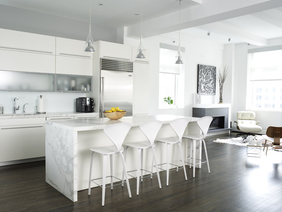 Example of a trendy open concept kitchen design in New York with white cabinets, marble countertops, stainless steel appliances, gray countertops and flat-panel cabinets