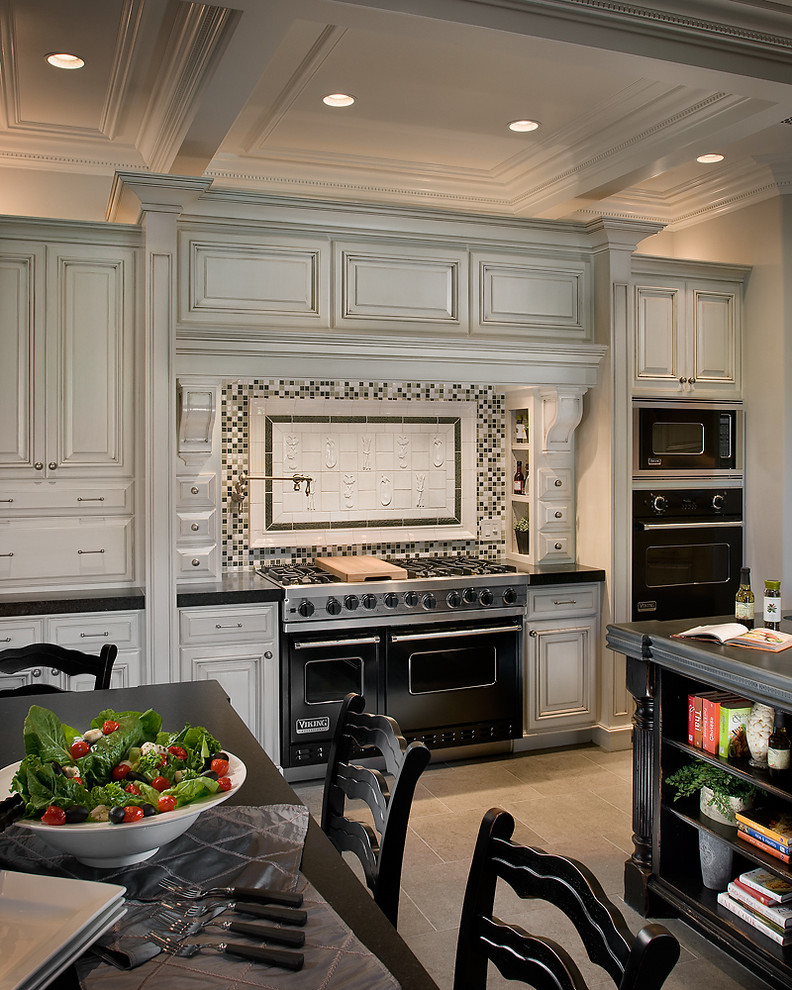 Classic grey and white kitchen in Phoenix with black appliances.