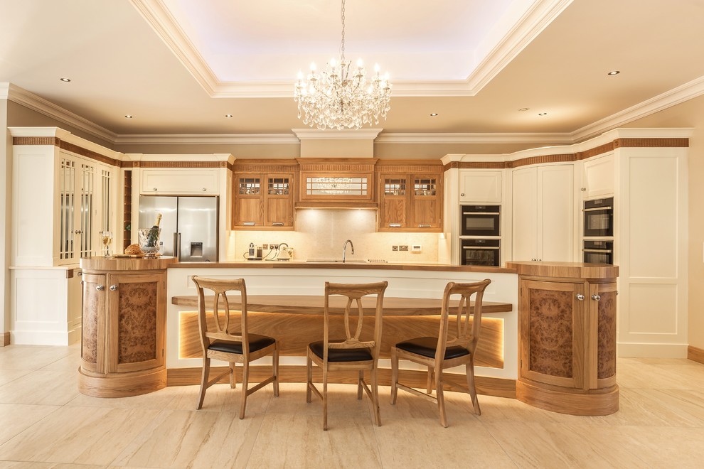 This is an example of a large classic u-shaped open plan kitchen in Other with an integrated sink, beaded cabinets, medium wood cabinets, quartz worktops, porcelain flooring and an island.